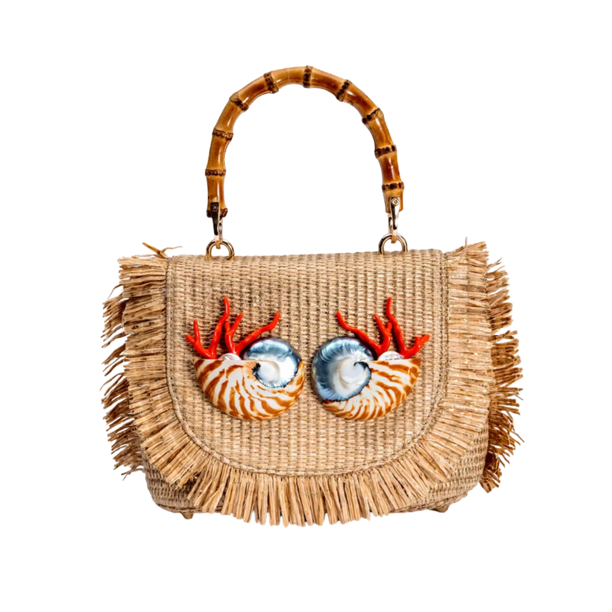 A woven straw handbag with a frayed fringe, a curved bamboo handle, and two large decorative shell eyes with red-orange coral-like details on the front, shown on a plain white background.