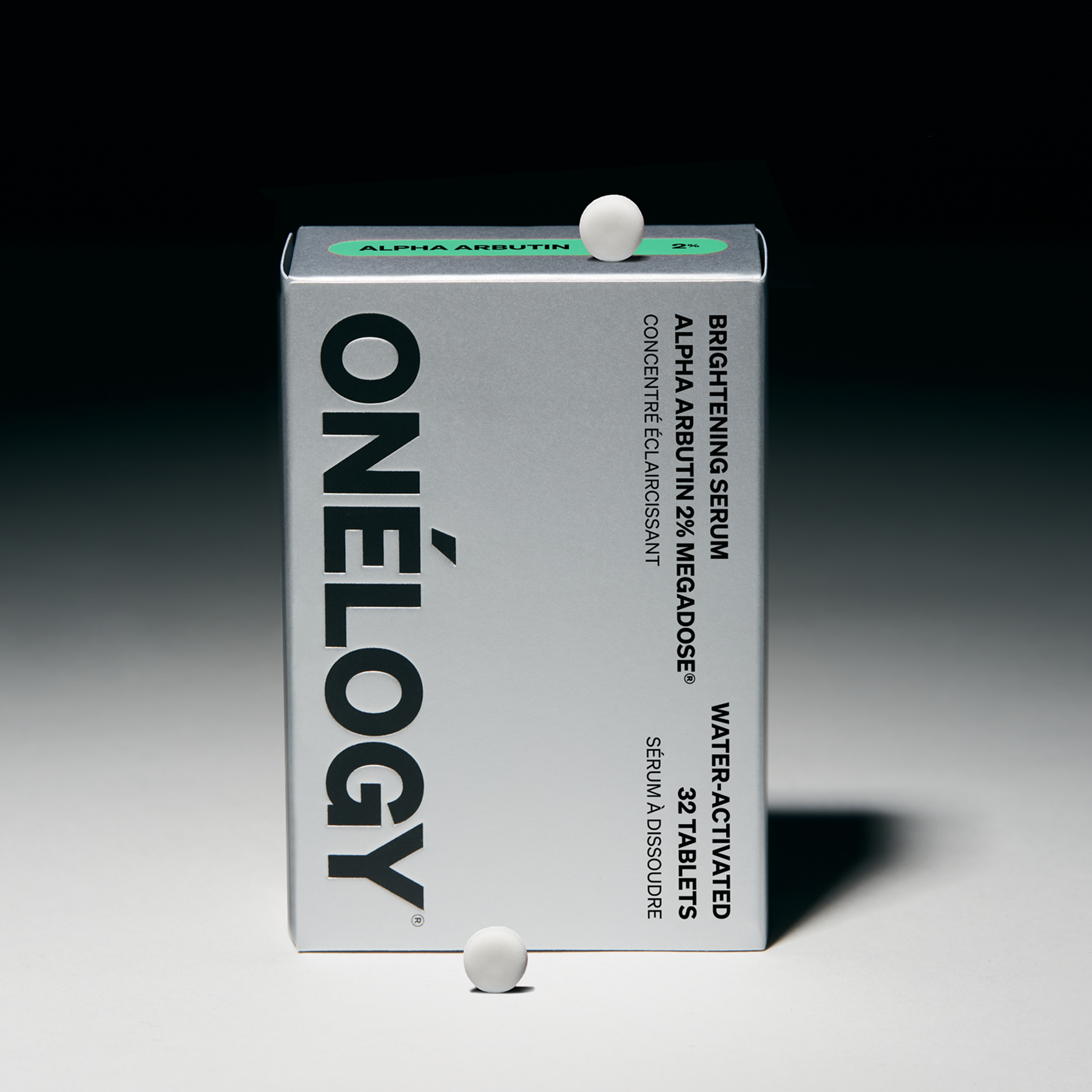 Onélogy brightening serum packaging with a white tablet on a gradient background