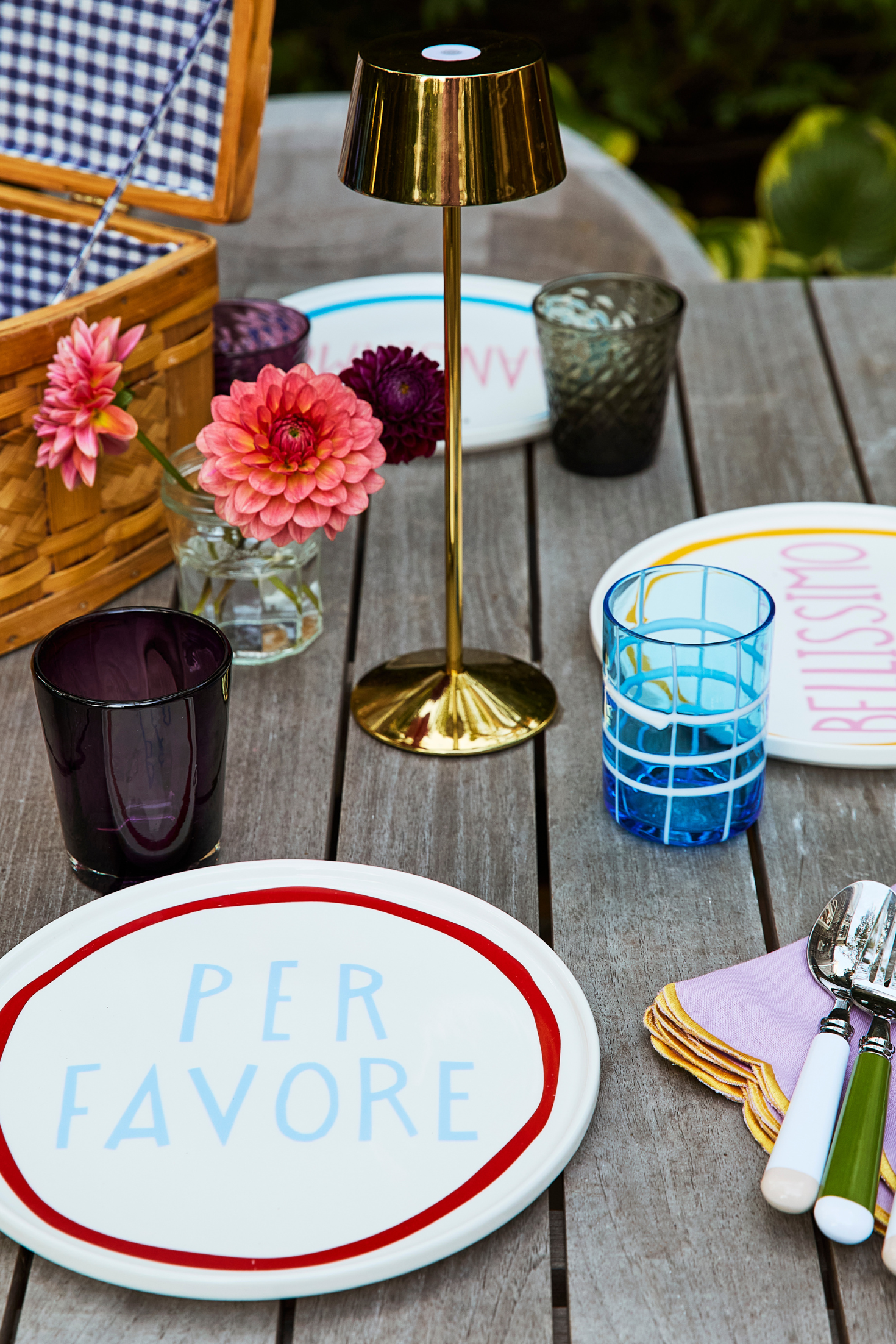 A tea lamp sitting in the middle of colorful tableware