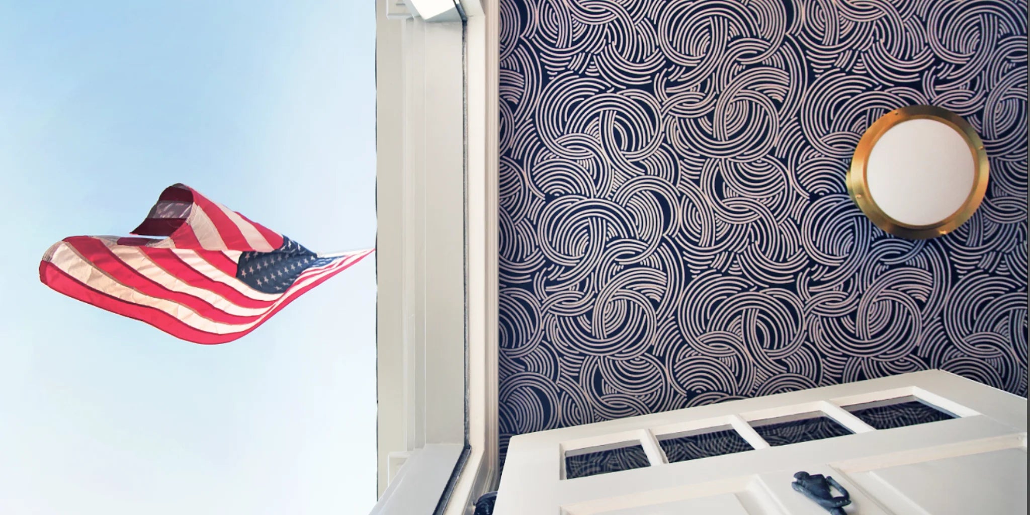 American Flag next to a purple striped ceiling with a flush mount