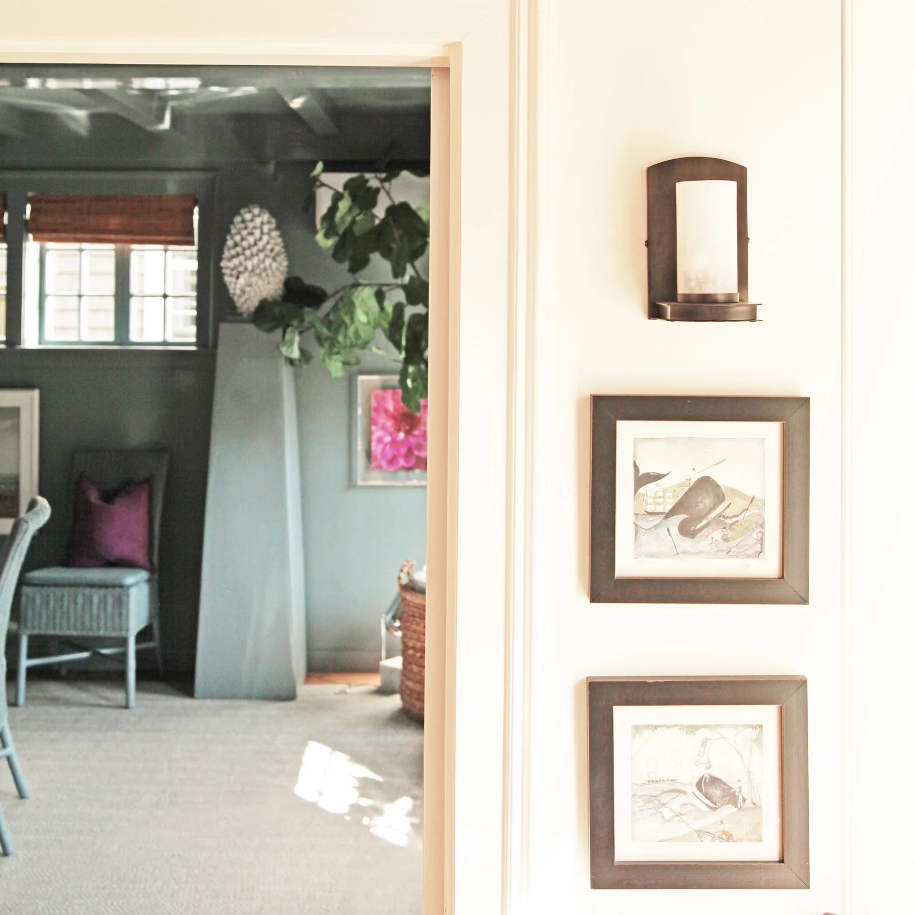 3 photos hanging next to a doorway