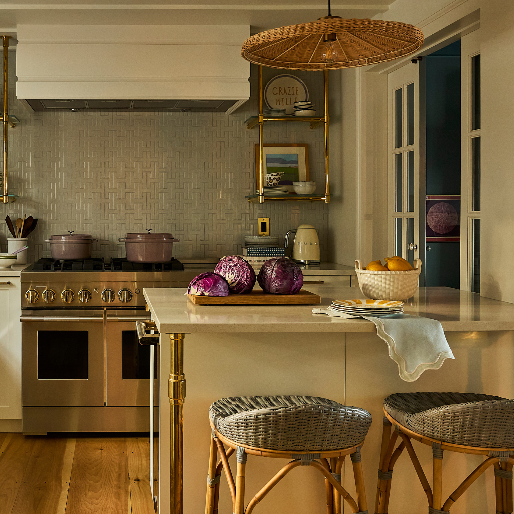 Modern kitchen with stainless steel appliances, wooden floors, and a breakfast bar.