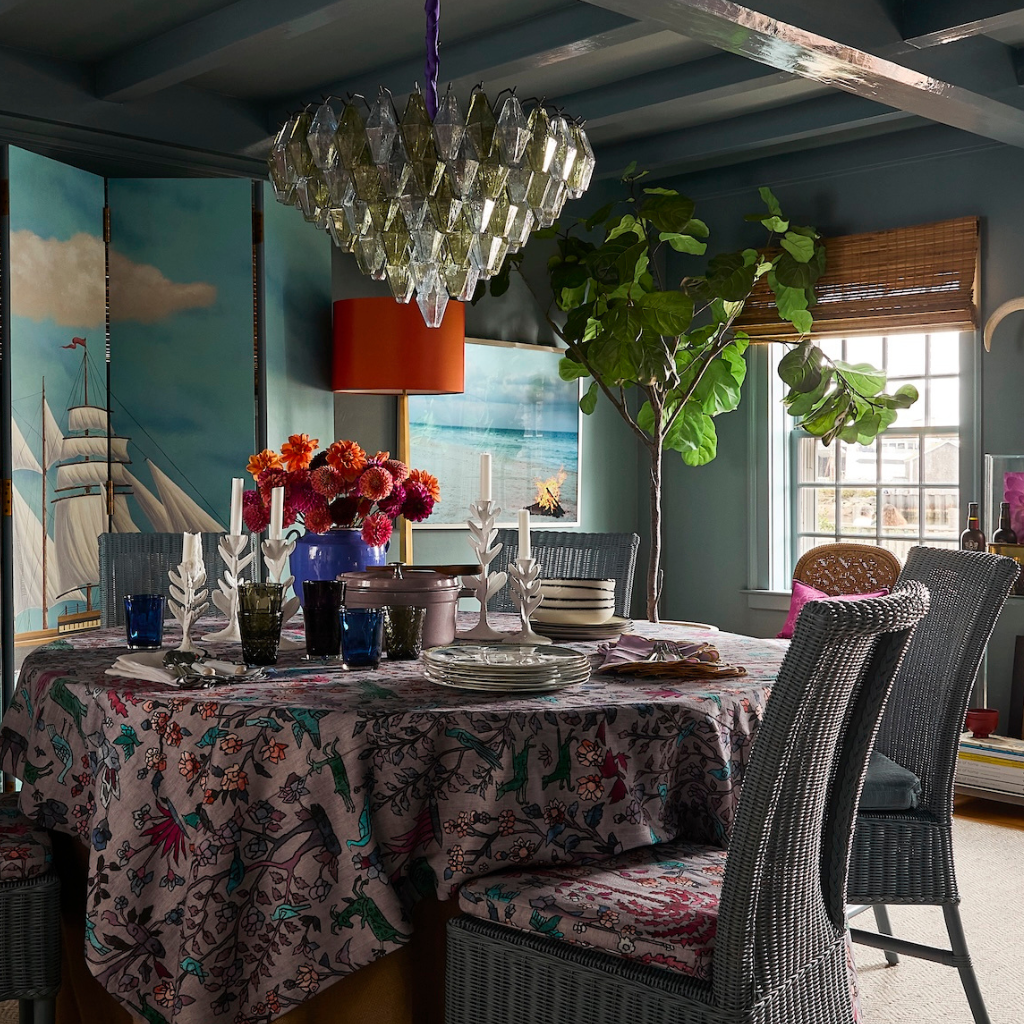 Dining room with a table set for a meal, floral centerpiece, and decorative elements.