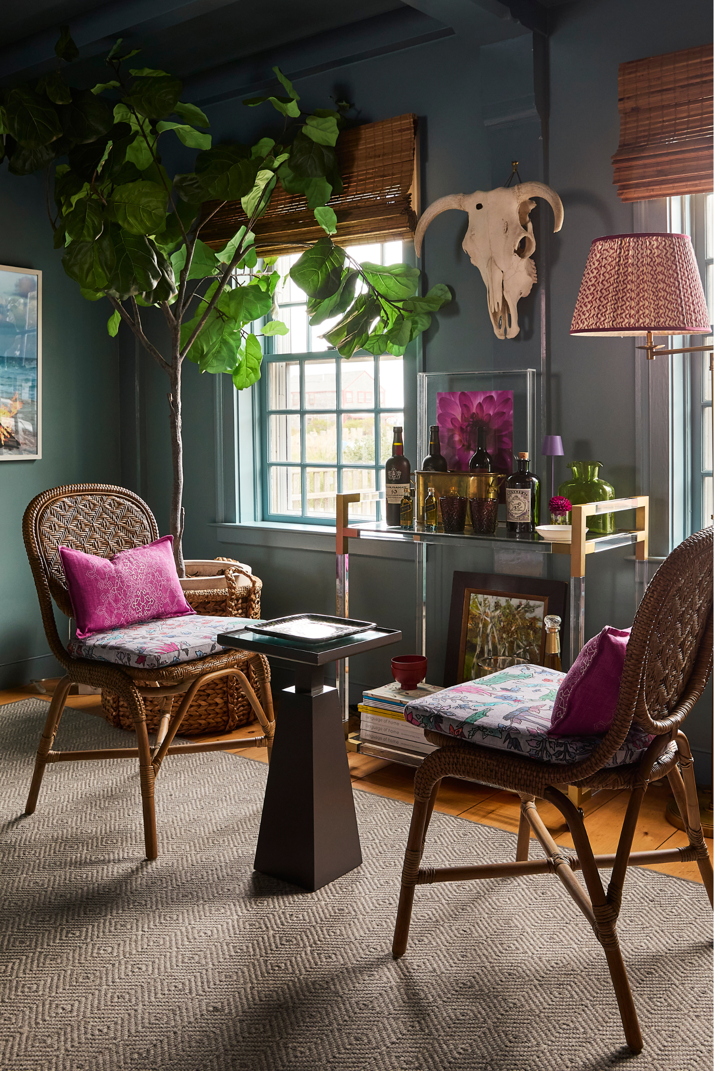 Cozy living room with wicker chairs, decorative pillows, and a small table.