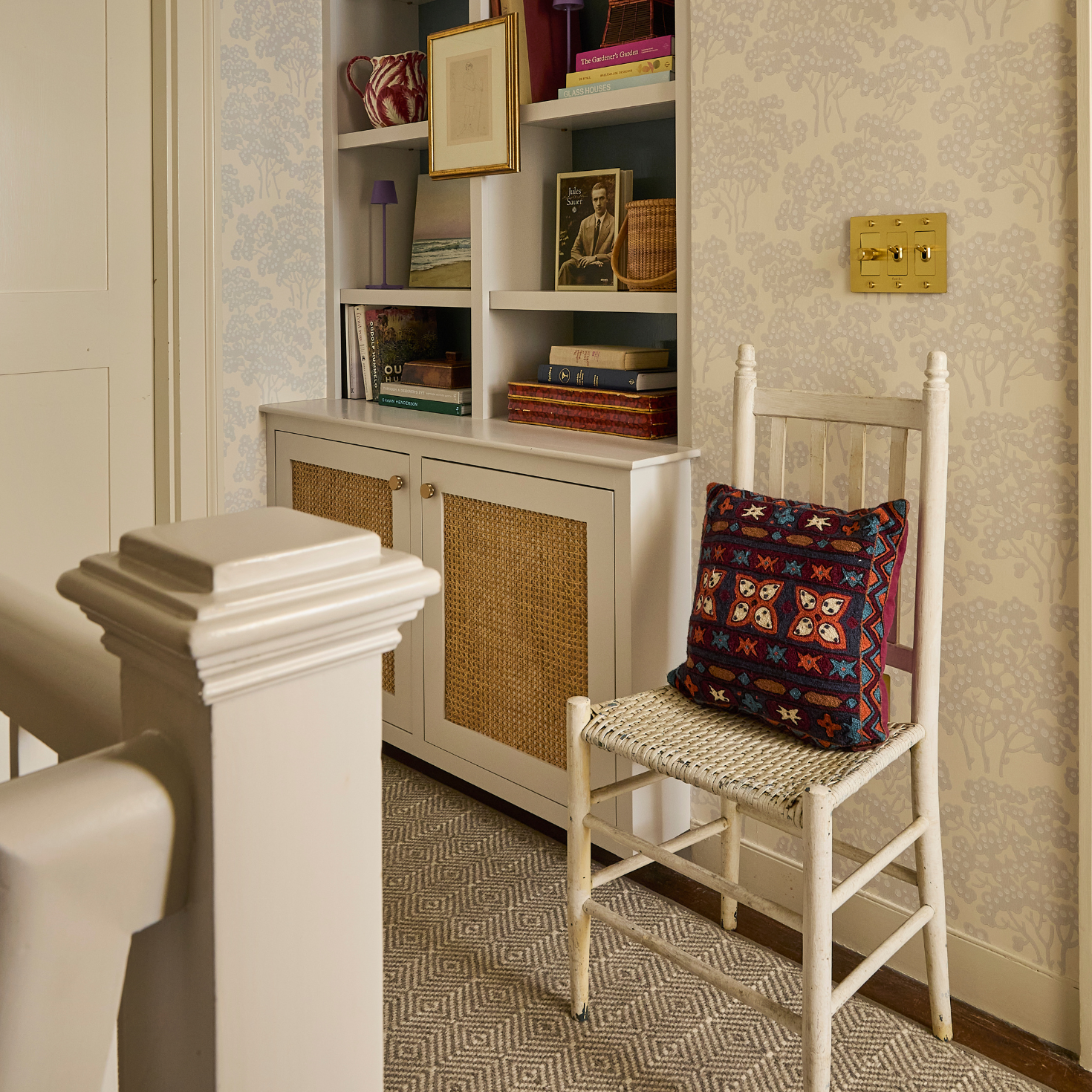 Small room with a bookshelf, chair, and decorative items.